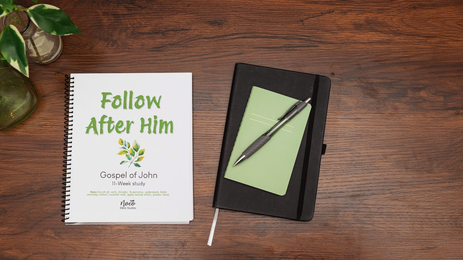 Gospel of John bible study workbook on wooden table with Bible
